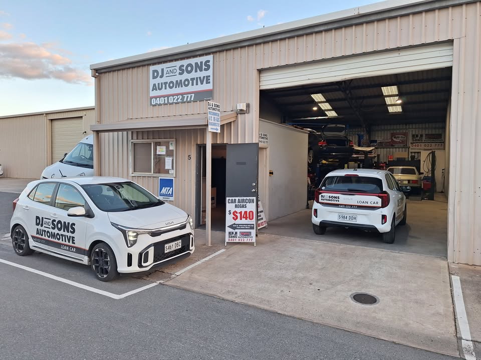 DJ and Sons Automotive workshop entrance and branded vehicles
